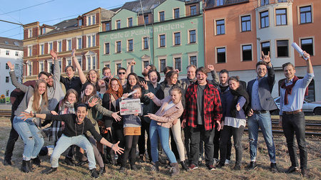 A group of young people standing next to each other.